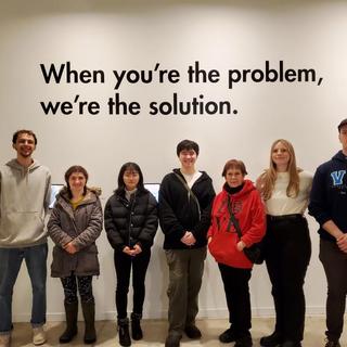 ANTH 335 VAG Field Trip, 20 January 2024.  Students in front of exhibit, "When you're the problem..."